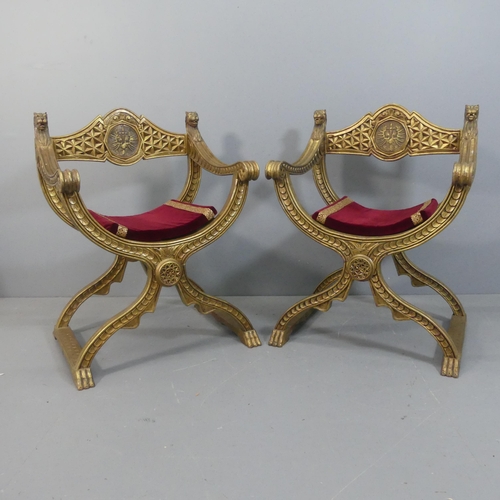 2069 - A pair of gilt-painted Savanarola style chairs, with lion mounts and carved decoration.