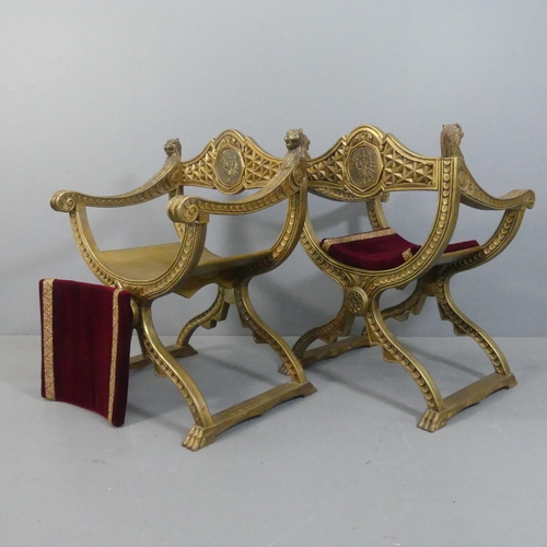 2069 - A pair of gilt-painted Savanarola style chairs, with lion mounts and carved decoration.