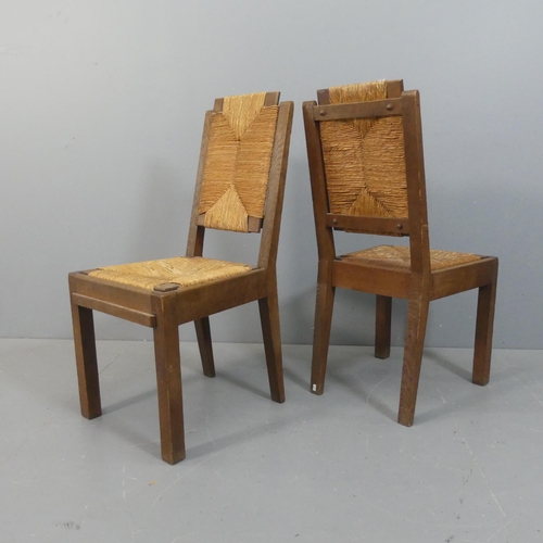 2071 - CHARLES DUDOUYT - A set of four mid-century brutalist oak dining chairs, each with rush drop-in seat... 