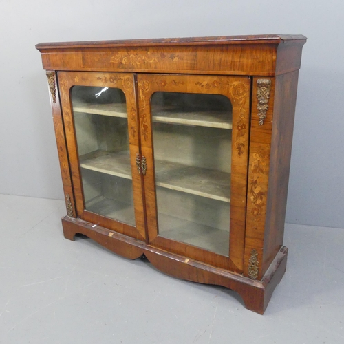 2072 - A 19th century French walnut bookcase, with two glazed panelled doors, and carved and inlaid maruetr... 