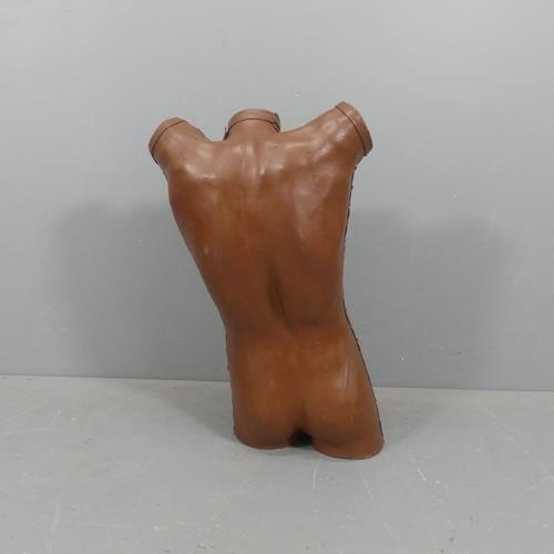 2239 - A mid-century fibre glass male torso clad in leather. Height 83cm.