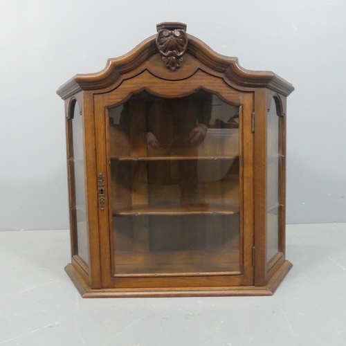 2241 - A continental oak hanging display cabinet of canted form. Width 70cm, height 60cm, depth 26cm.