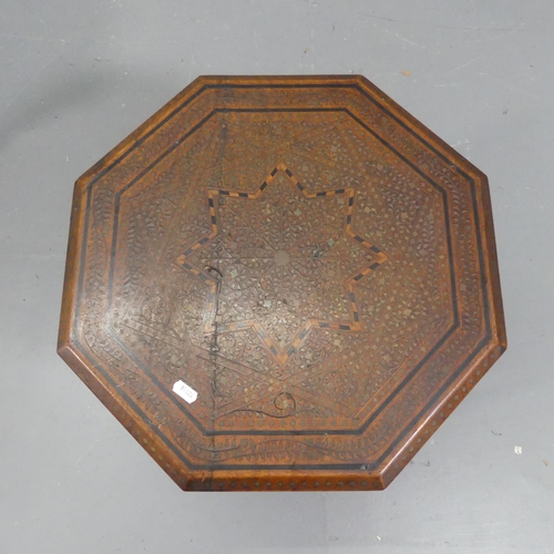 2249 - An Anglo-Indian teak octagonal occasional table, with inlaid ebony and brass decoration and folding ... 