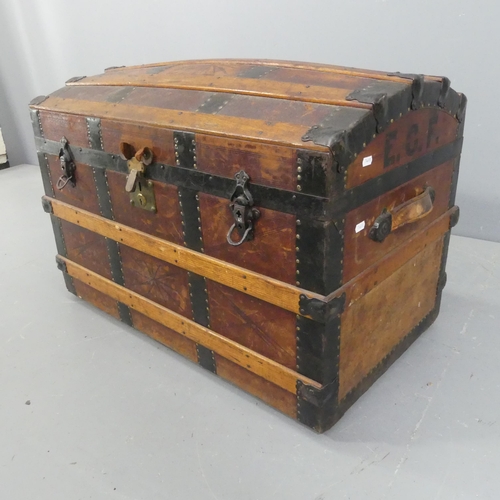 2256 - A Victorian leather covered dome-top trunk with tooled and embossed decoration, marked E.C.F. Width ... 