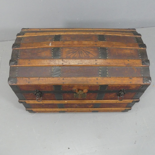 2256 - A Victorian leather covered dome-top trunk with tooled and embossed decoration, marked E.C.F. Width ... 