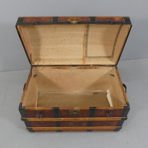 2256 - A Victorian leather covered dome-top trunk with tooled and embossed decoration, marked E.C.F. Width ... 