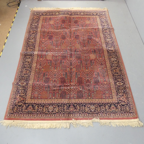 2300 - A red-ground Persian machine made rug. Length 242cm, width 160cm.