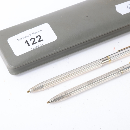 438 - 2 slimline sterling silver ballpoint pens with fluted bodies, both marked 925