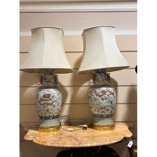 48 - A pair of Chinese famille rose porcelain lamps, with enamel dragon decoration and gilt-metal mounts,... 