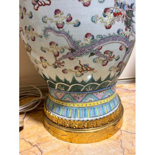 48 - A pair of Chinese famille rose porcelain lamps, with enamel dragon decoration and gilt-metal mounts,... 