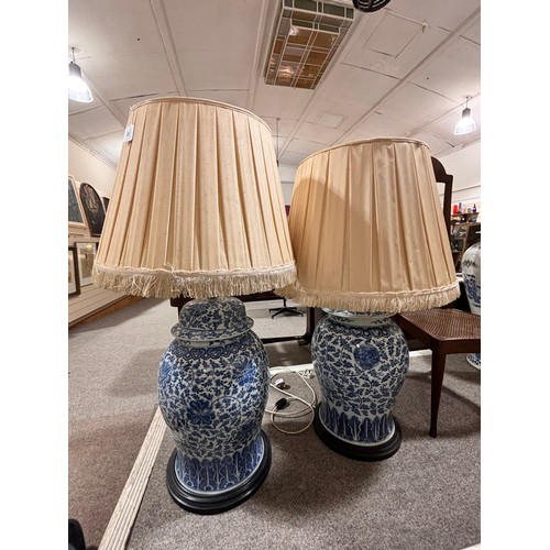 52 - A large pair of Chinese blue and white porcelain lamps on wooden bases, height to top of covers 65cm