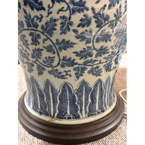 52 - A large pair of Chinese blue and white porcelain lamps on wooden bases, height to top of covers 65cm