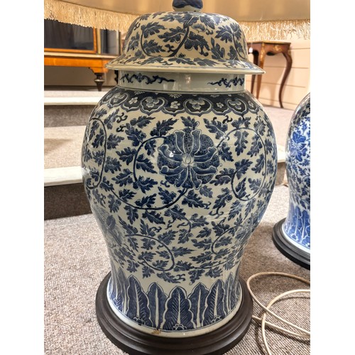 52 - A large pair of Chinese blue and white porcelain lamps on wooden bases, height to top of covers 65cm