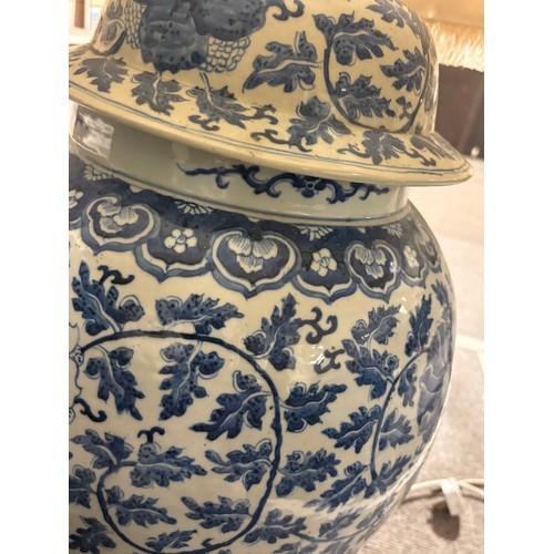 52 - A large pair of Chinese blue and white porcelain lamps on wooden bases, height to top of covers 65cm