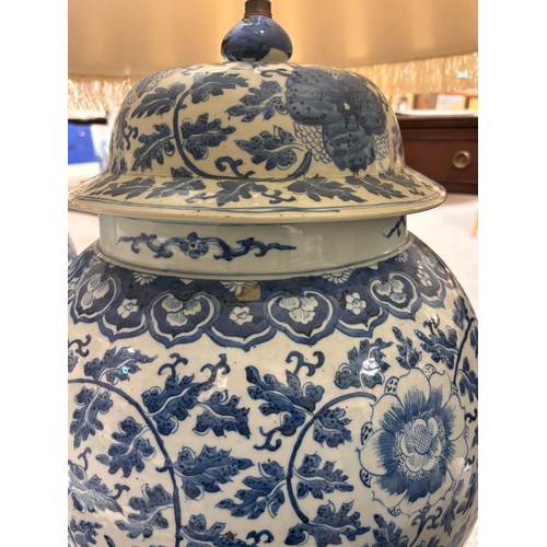 52 - A large pair of Chinese blue and white porcelain lamps on wooden bases, height to top of covers 65cm