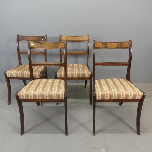 2438 - A set of four mahogany and upholstered Regency style dining chairs with inlaid brass decoration.