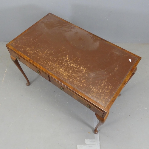 2302 - A Victorian walnut writing table, with two drawers and cabriole legs. Width 110cm, height 76cm, dept... 