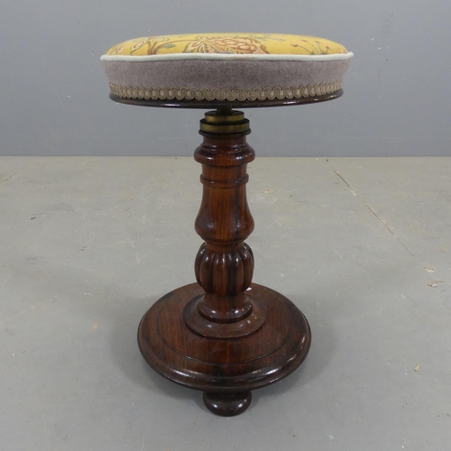 2305 - A 19th century rosewood and upholstered piano stool. Diameter 33cm, height 49cm.