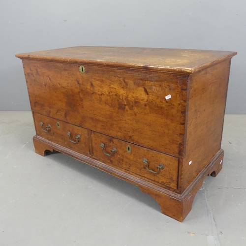 2310 - A vintage stained pine blanket box, with lifting lid, two drawers under and raised on bracket feet. ... 