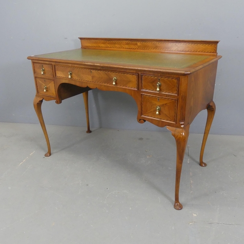 2326 - A modern walnut veneered continental style writing table, with raised back, tooled and embossed leat... 