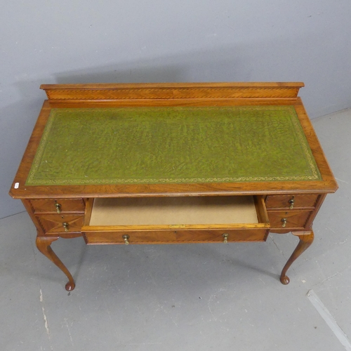 2326 - A modern walnut veneered continental style writing table, with raised back, tooled and embossed leat... 