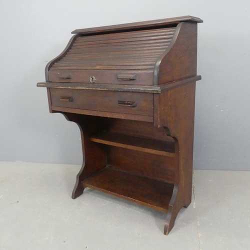 2328 - An early 20th century oak roll top student's bureau, with fitted interior, drawers under and shelves... 