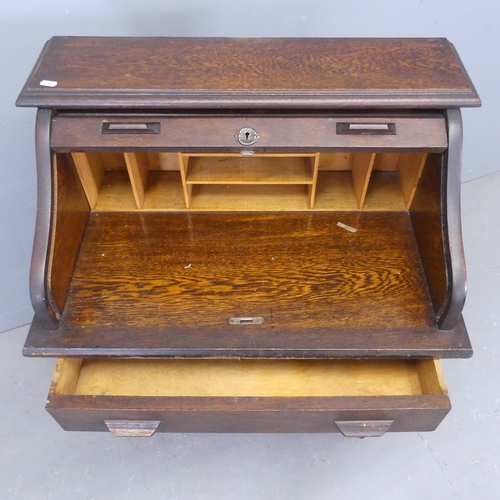 2328 - An early 20th century oak roll top student's bureau, with fitted interior, drawers under and shelves... 