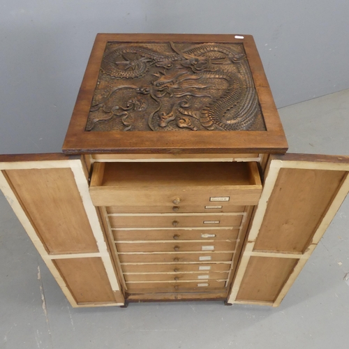 2331 - A mahogany collector's cabinet, with two panelled doors revealing eleven drawers and Chinese Dragon ... 