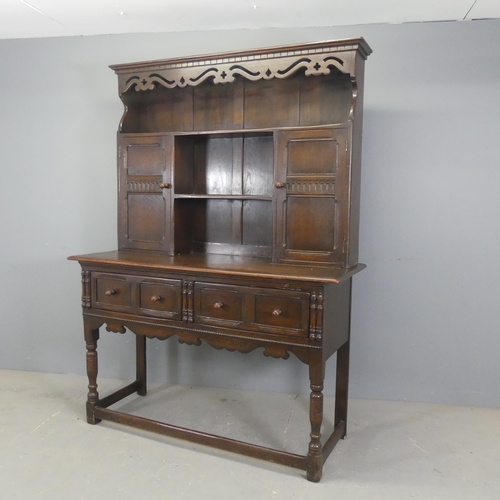 2333 - A two-section oak dresser, with open plate rack, two cupboards and two drawers. Width 138cm, height ... 