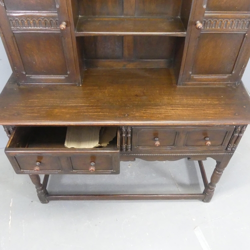 2333 - A two-section oak dresser, with open plate rack, two cupboards and two drawers. Width 138cm, height ... 