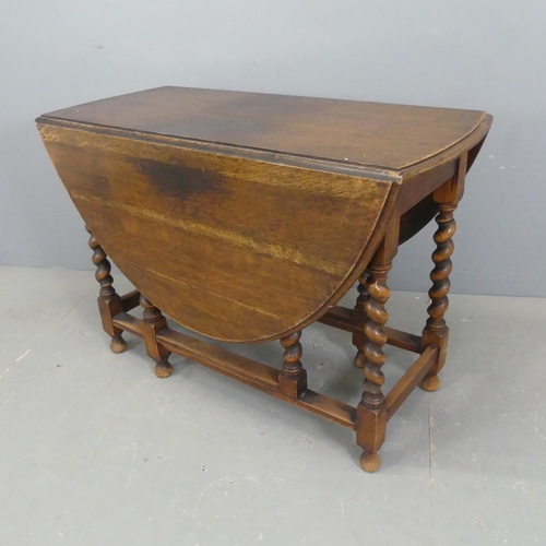 2334 - An early 20th century oak oval gate-leg drop-leaf table, with barley twist supports. Length 104cm, h... 