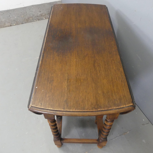 2334 - An early 20th century oak oval gate-leg drop-leaf table, with barley twist supports. Length 104cm, h... 