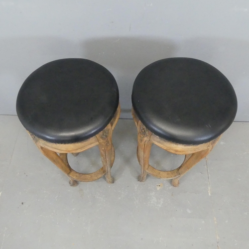 2340 - A pair of French oak and faux-leather upholstered bar stools. Height 76cm.