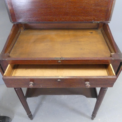 2342 - An antique oak two-tier clerk's desk, with lifting lid, drop side-leaves and raised on tapered legs.... 