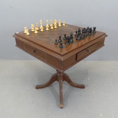 2343 - A modern mahogany games-top table, with two drawers, and raised on a turned central column with quad... 