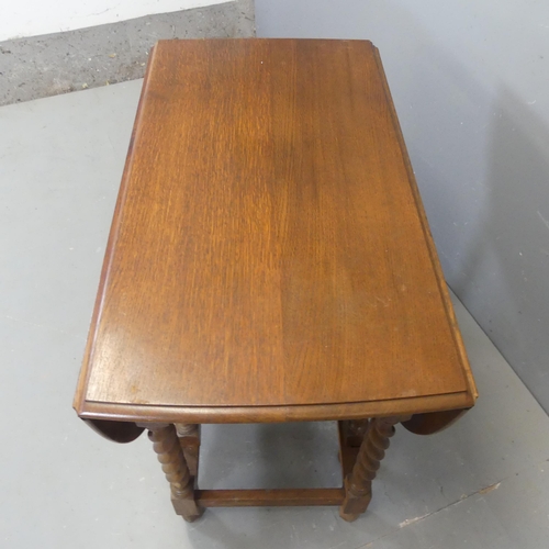 2346 - An oak oval barley-twist gate-leg drop-leaf table. Width 92cm, height 76cm, depth 50cm.