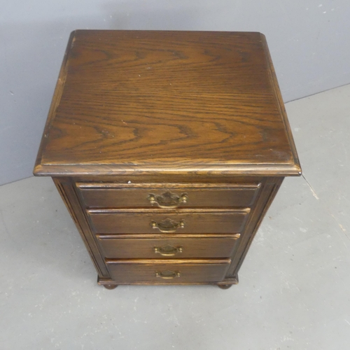 2357 - A panelled oak bedside chest of four drawers. Width 46cm, height 70cm, depth 40cm.