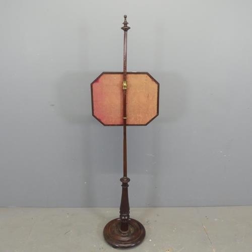 2360 - A 19th century mahogany and upholstered pole screen. Height 140cm.