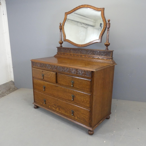 2361 - A 1930s oak dressing chest, with raised mirror back, a concealed drawer containing an integral jewel... 