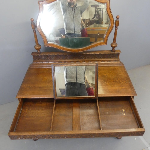 2361 - A 1930s oak dressing chest, with raised mirror back, a concealed drawer containing an integral jewel... 