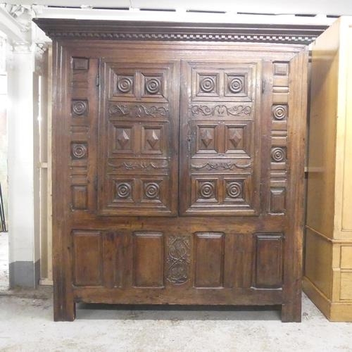 2364 - A 17th century and later panelled oak larder cupboard, with two doors revealing a shelf fitted inter... 