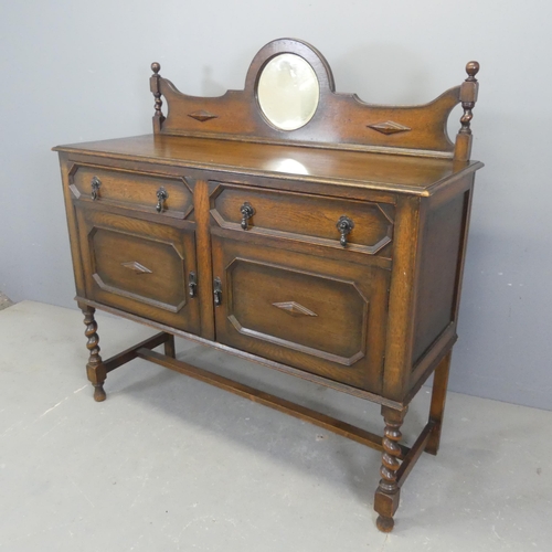 2374 - A 1930s oak Jacobean style sideboard, with raised mirror back, two drawers, cupboards under and barl... 