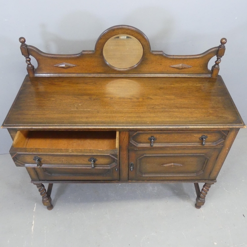 2374 - A 1930s oak Jacobean style sideboard, with raised mirror back, two drawers, cupboards under and barl... 