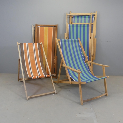 2437 - Two sets of three vintage 1970s deck chairs, with fabric sling seats on teak frames.