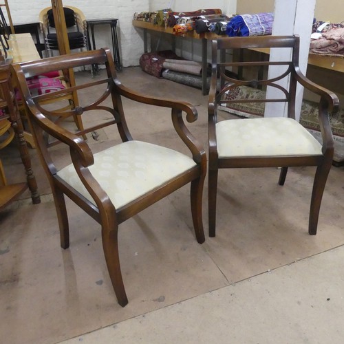 2477 - A pair of Regency style mahogany and upholstered open arm chairs.