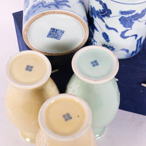 148 - A pair of Chinese blue and white ceramic brush pots, H13.5cm, boxed, a pair of Chinese celadon groun... 