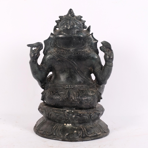 153 - A cast black metal study of Ganesh on lotus stand, H29cm