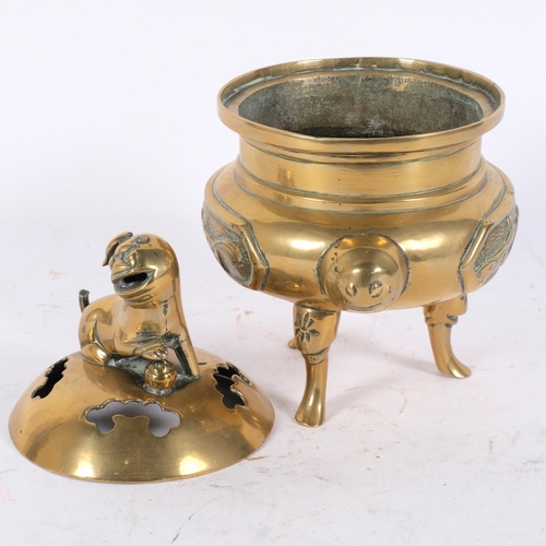 157 - A Chinese bronze censer, raised on 3 feet, having a pierced lid with dog of fo knop, H22cm