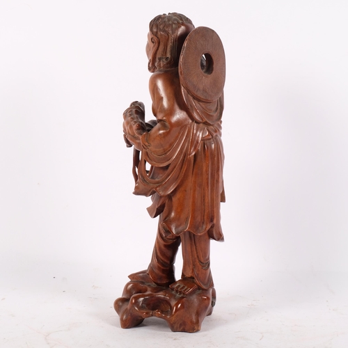 158 - A Chinese carved hardwood figure of an immortal (Liu Hai), H30cm