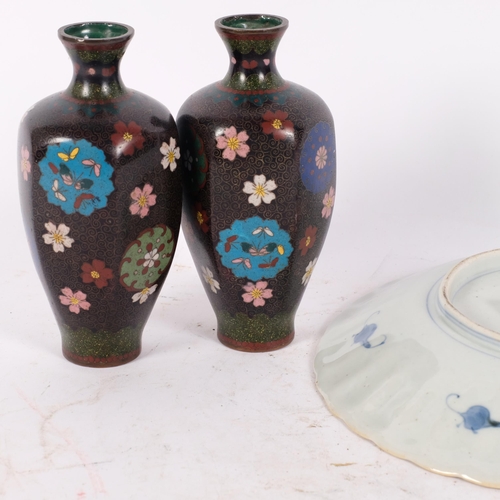 164 - A pair of Oriental black ground cloisonne vases of panelled form, H16cm, and a Japanese white Satsum... 